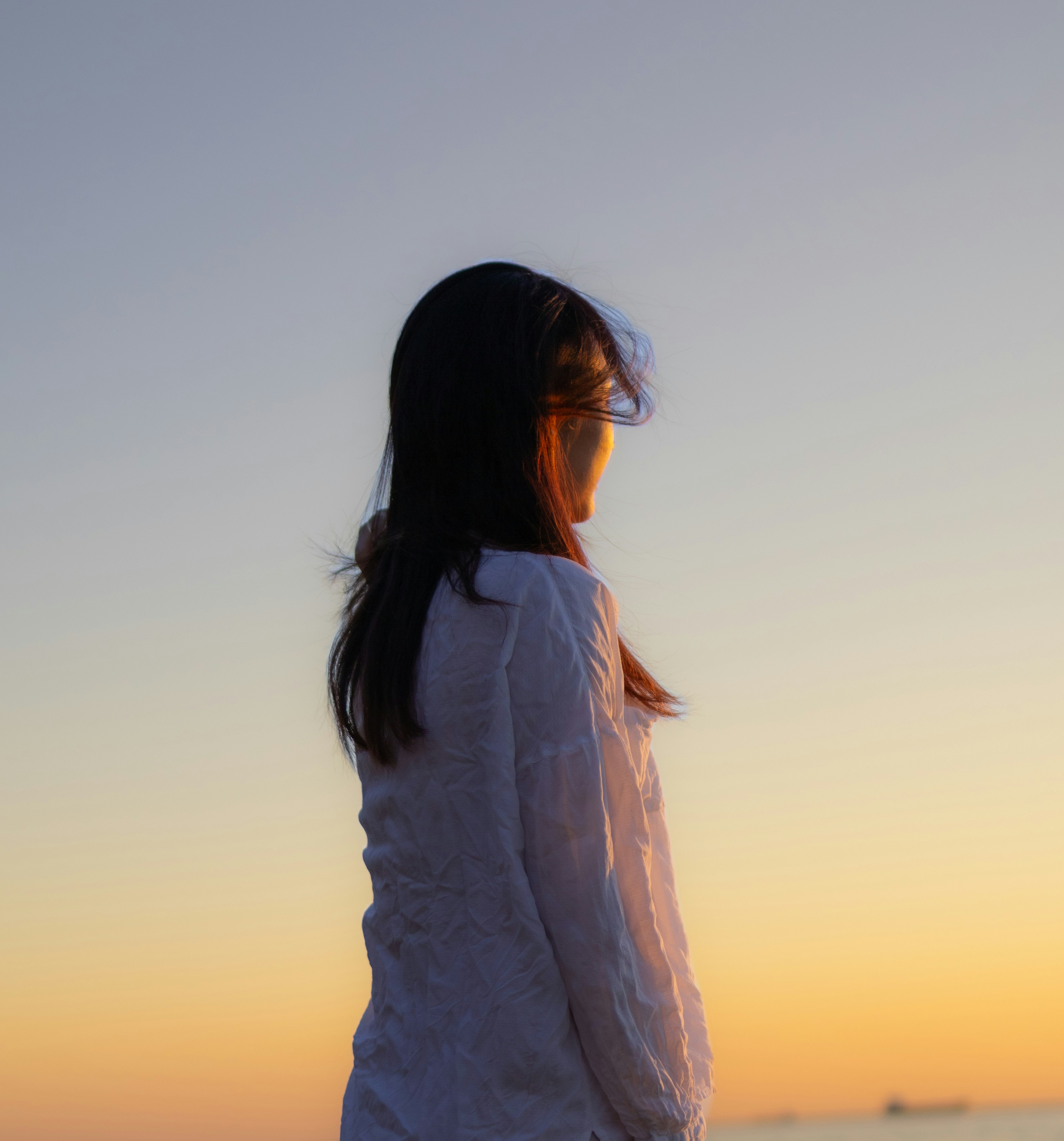 Calm silhouette looking toward a warm horizon
